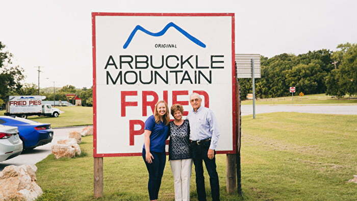 Family standing in front of Arbuckle Mountain Fried Pies sing in Oklahoma