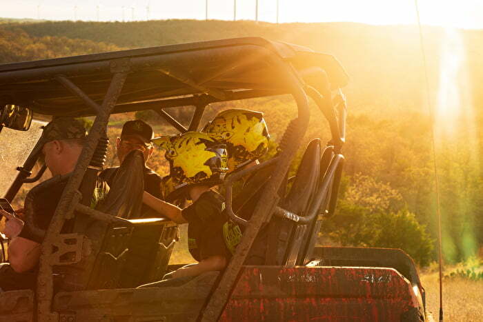 Dads and sons in a utility vehicle at Crossbar Ranch Offroad Park in Davis Oklahoma