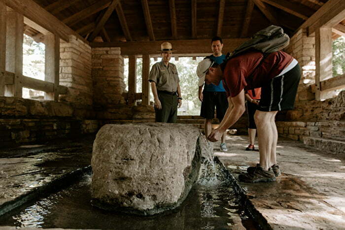 Man hiking and washing hands at chickasaw nation recreation area