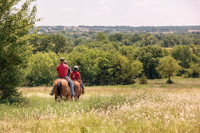 Group horseback riding on trails in Chickasaw Country