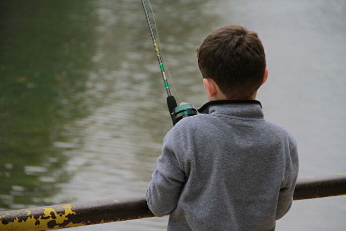 Boy fishing outdoors in Chickasaw Country