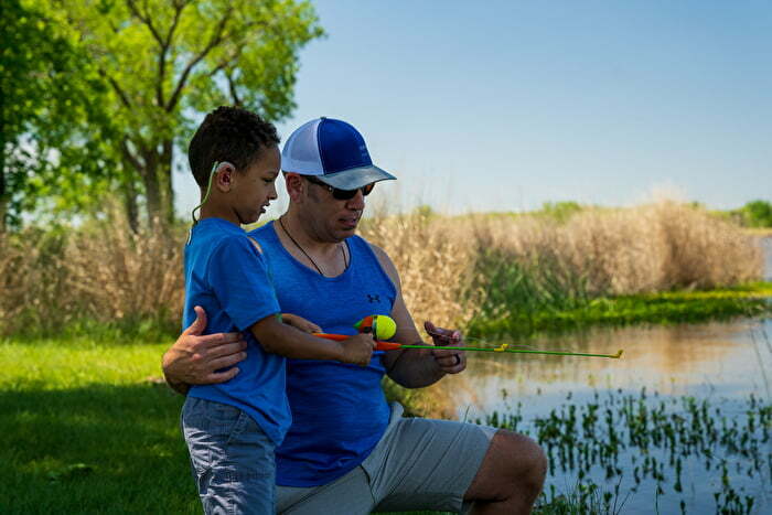 Man teaches child how to fish at a lake in Oklahoma