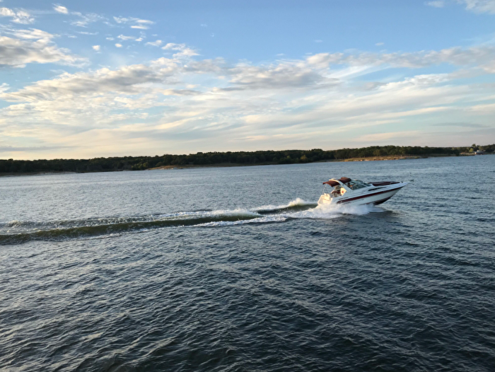 A boat cruising on a lake in Chickasaw Country